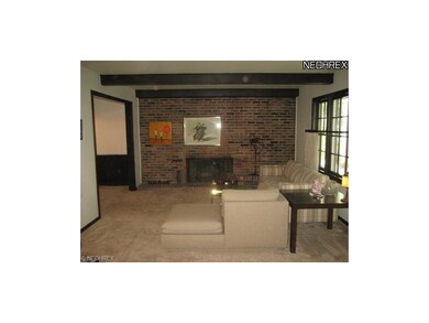 Charming Living Room with Beamed Ceiling and Brick