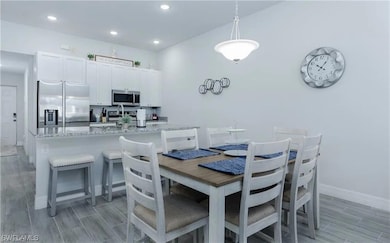 Dining area featuring baseboards, recessed lightin