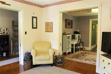 Living room with pocket doors to foyer and den/off