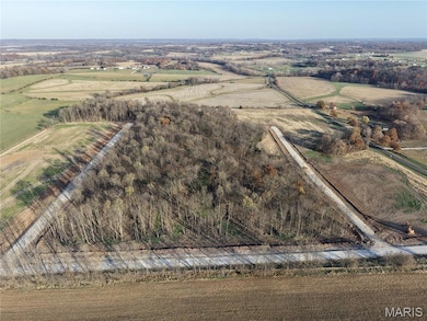 Aerial view of property's location with rural landscape and large plots for crops