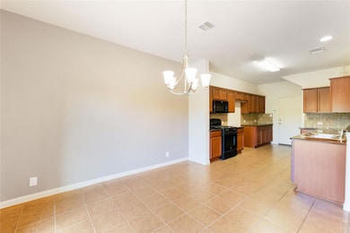 Kitchen with decorative backsplash, visible vents