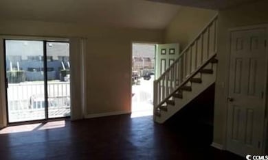Entryway with stairway, baseboards, and dark wood-style floors