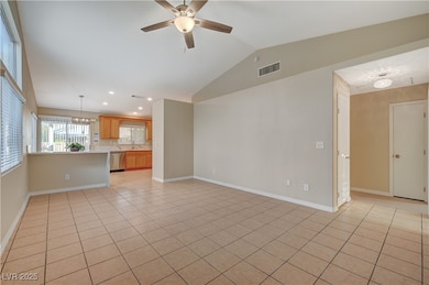 Unfurnished living room featuring light tile patte