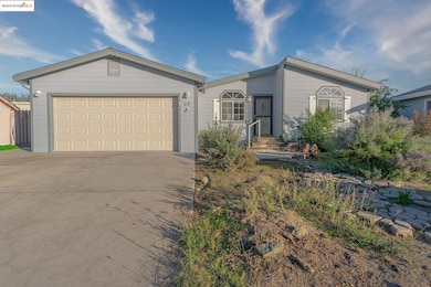 Ranch-style house with concrete driveway and an attached garage