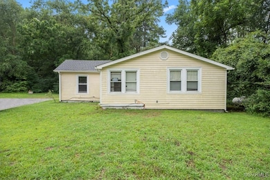 Back of house featuring a yard
