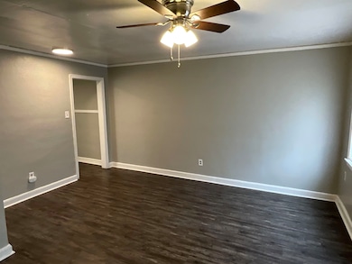 Unfurnished room featuring dark wood-type flooring