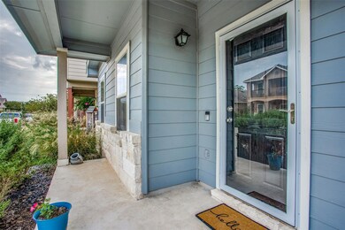 Entrance to property with stone siding and covere