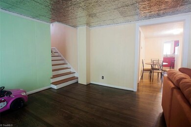 Den looking into the breakfast room and kitchen
