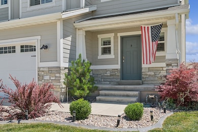 Property entrance with stone siding and covered porch