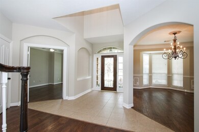 The tiled foyer is flanked by a study and formal dining room.