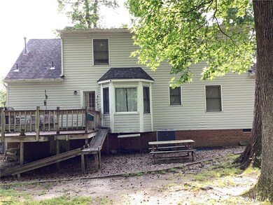 Rear view of property featuring a shingled roof, a