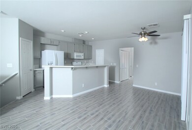 Kitchen with white appliances, visible vents, ligh