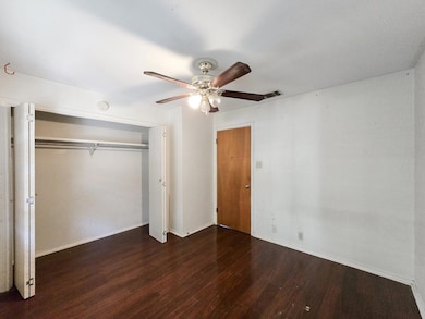 Unfurnished bedroom with wood finished floors, a 