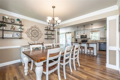 Dining area featuring crown molding, dark wood-typ