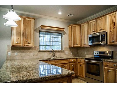 Kitchen. Beautiful granite counters, custom cabinets, built-in microwave, oven, dishwasher and more.