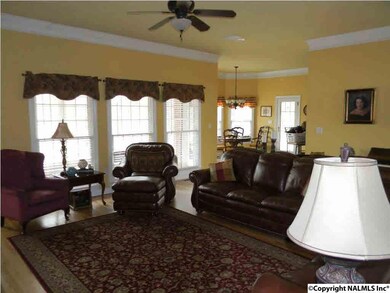 ANOTHER VIEW OF LIVING ROOM WITH LOADS OF NATURAL LIGHT AND WOOD FLOORS.