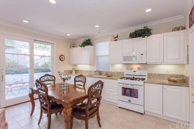 White cabinetry and marble counters in the kitchen
