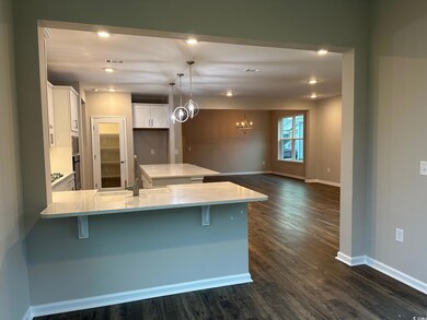 Kitchen featuring white cabinetry, kitchen peninsu