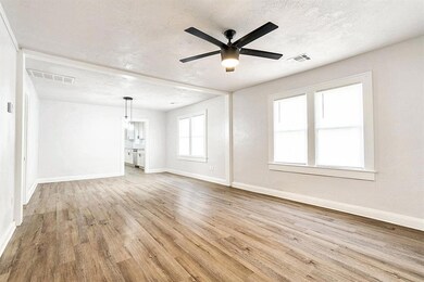 Unfurnished living room with a textured ceiling, c