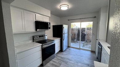 Kitchen with light stone counters, stainless steel