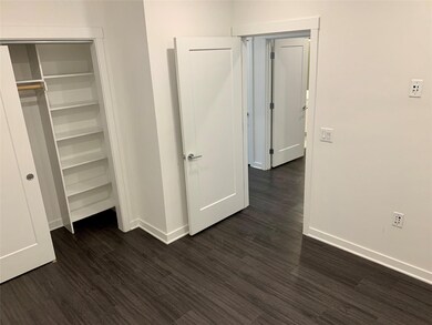 Unfurnished bedroom with dark wood finished floor