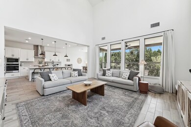 Living room featuring visible vents, light wood-t