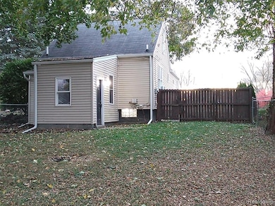 View of rear of home featuring a shingled roof