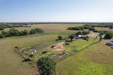 Aerial view of sparsely populated area. Fenced on 2.75 sides.