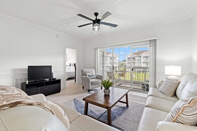 Living area featuring crown molding, light wood-type flooring, and a ceiling fan