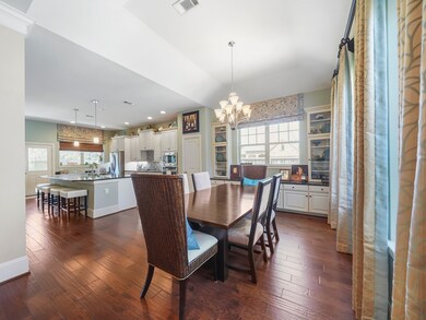 The dining area is highlighted by a stunning light