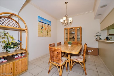 Dining area featuring a chandelier, ornamental mol