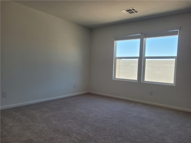 Carpeted spare room with baseboards