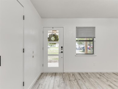 Foyer entrance featuring wood finished floors and 