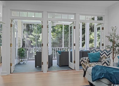 Entryway withLVP floors, crown molding, Leading to Screened in Porch