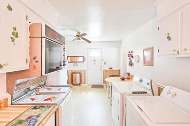 Kitchen includes stove, refrigerator, storage and eating area.