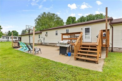 Rear view of property featuring a patio and a lawn