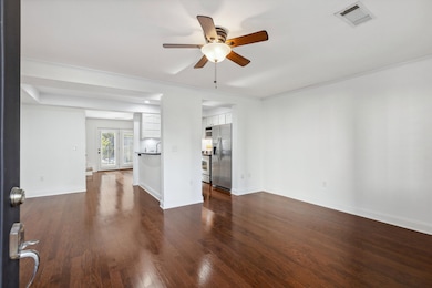 Unfurnished living room featuring visible vents, c
