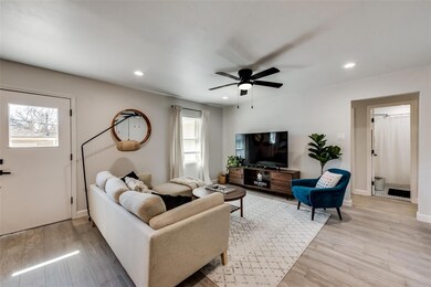 Living area featuring ceiling fan, light wood-type