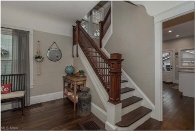 Detailed molding, ample lighting, and gorgeous staircase set the tone upon entering.