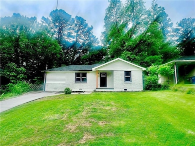 Ranch-style house with a front lawn and brick siding