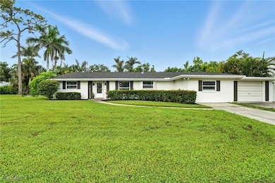 Single story home featuring a front lawn, stucco siding, and concrete driveway