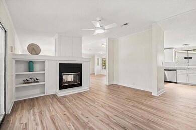 Built-Ins and Fireplace in Family Room looking into Kitchen and back towards the Dining Area and Front Door Entry.