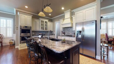 The kitchen has upgraded cabinets, luxury granite, double stainless steel ovens and more.