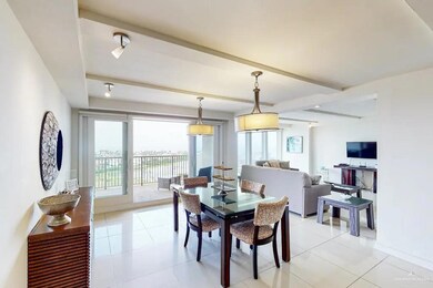 Dining room with beam ceiling and light tile floors