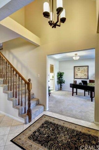 Dramatic vaulted entry with travertile floor.