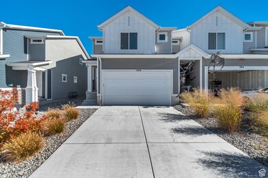 View of front of home featuring board and batten siding, concrete driveway, and an attached garage