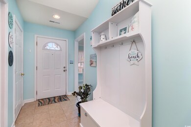 Mudroom featuring light tile patterned flooring an