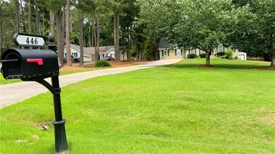 View of green lawn with concrete driveway