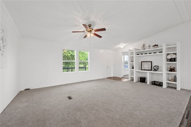 Unfurnished living room featuring ornamental moldi