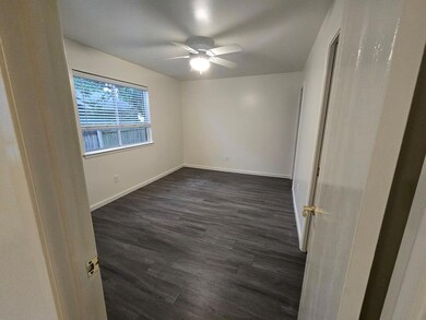 Unfurnished bedroom with dark wood-type flooring 